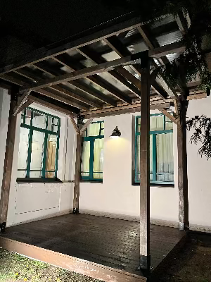 Wooden pergola structure with a building in the background