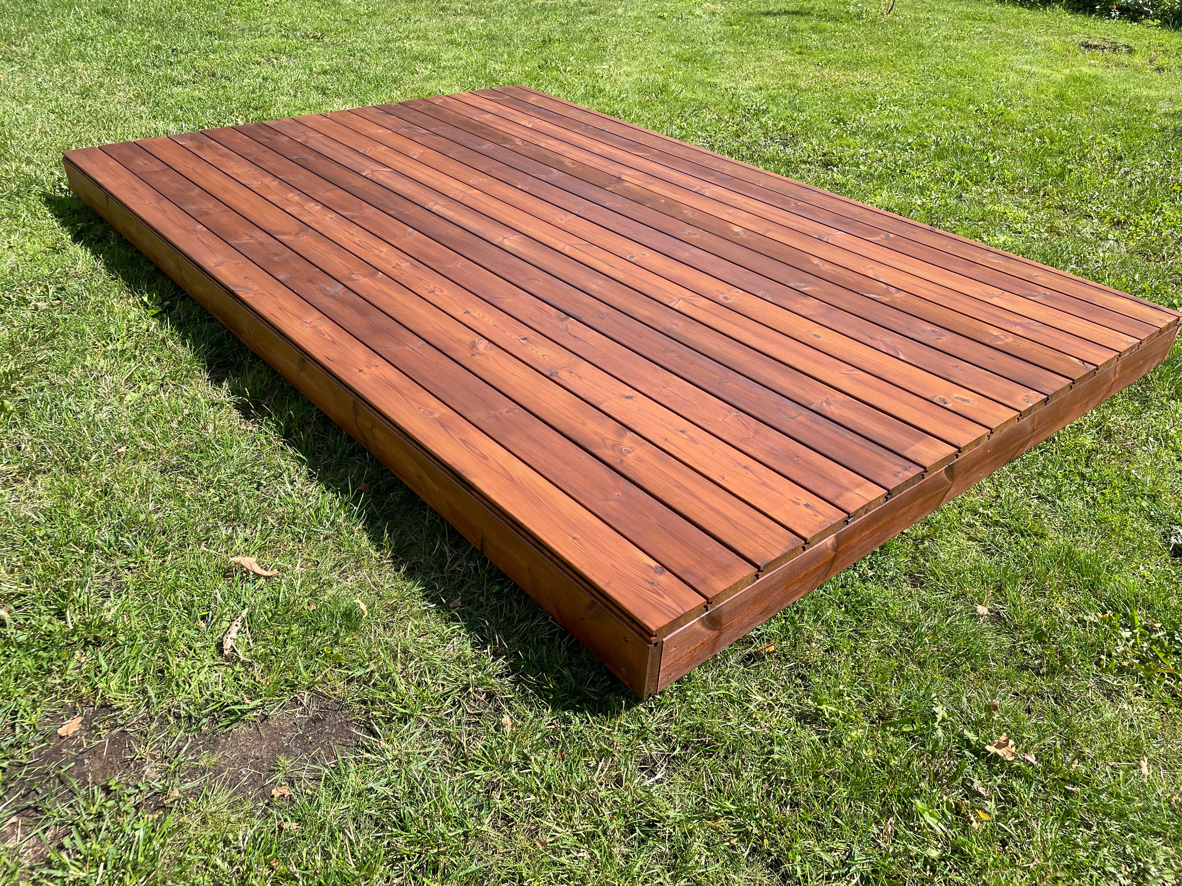 Wooden deck platform on grass