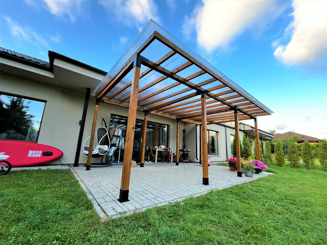 Patio with wooden pergola, outdoor furniture, and surfboard against a blue sky.