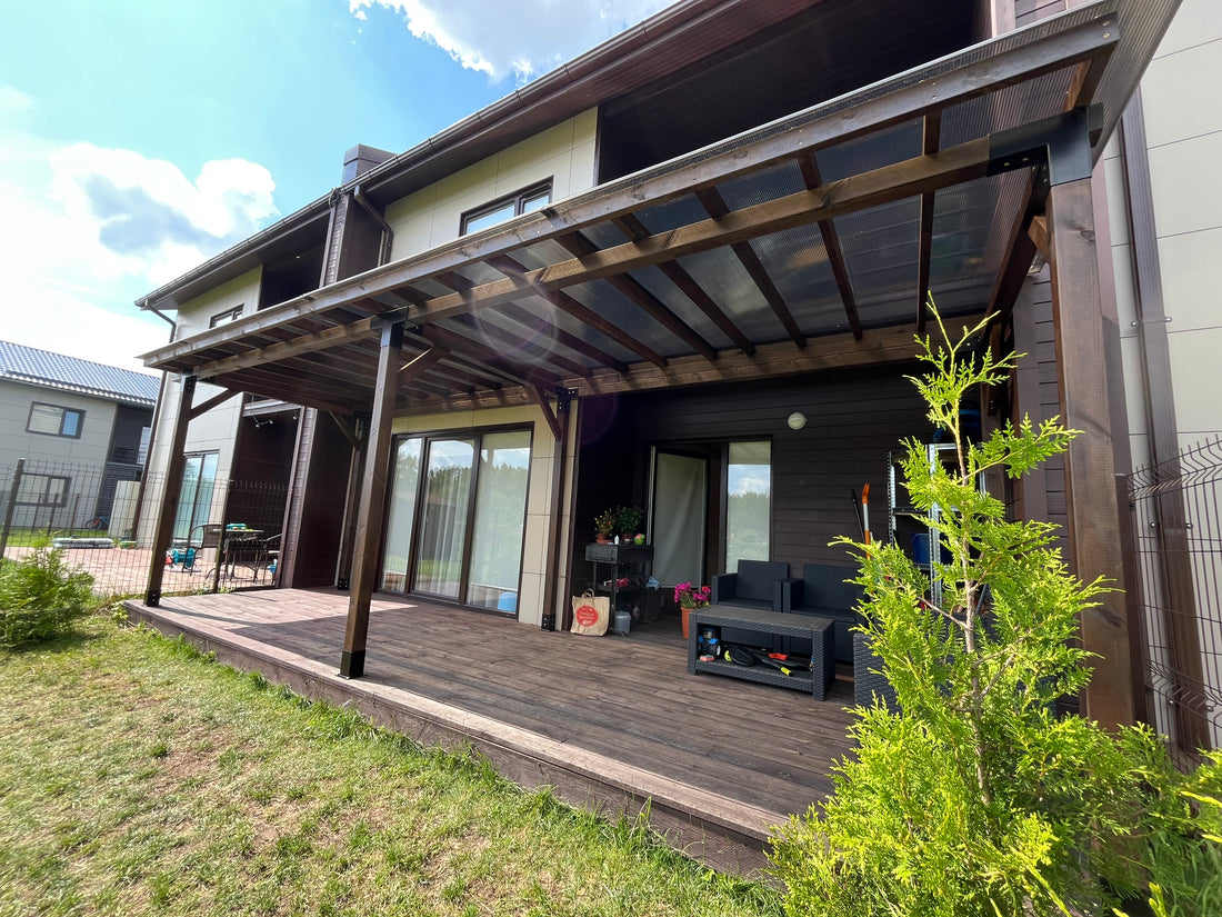 Modern house exterior with a wooden deck and outdoor furniture